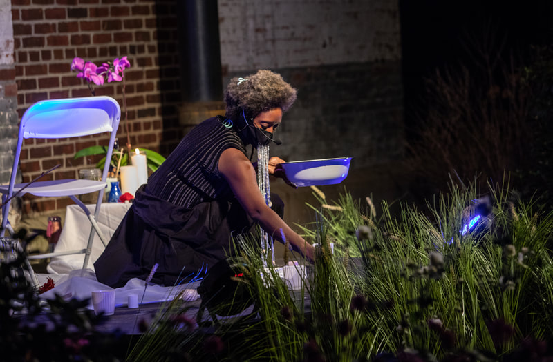 FIRE FLOWERS AND A​ ​TIME MACHINE // FLORES DE FUEGO Y UNA MÁQUINA DEL TIEMPO by Shey Rivera Ríos, presented by The Wilbury Theatre Group in collaboration with WaterFire Providence; photo by Erin X. Smithers. (Providence, RI)